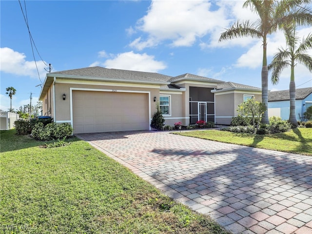 view of front of property with a front yard, a garage, and a sunroom