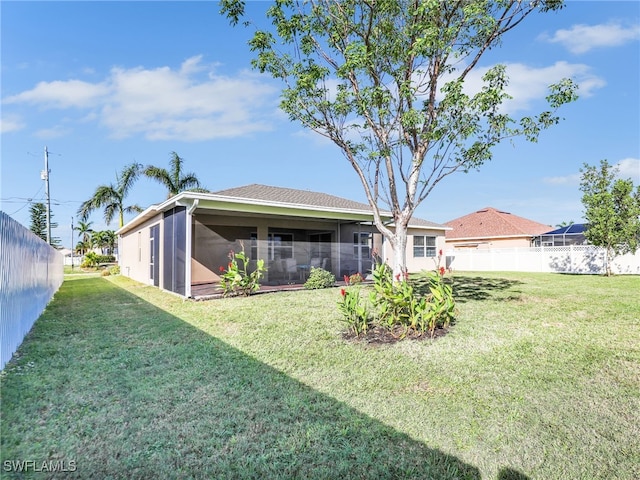 rear view of property with a lawn