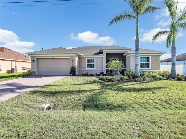 ranch-style home with a garage, a front yard, and central AC