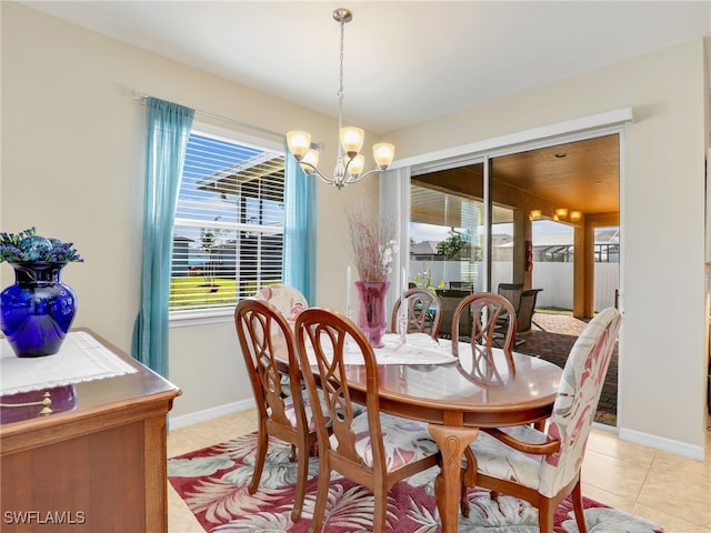 tiled dining room featuring an inviting chandelier