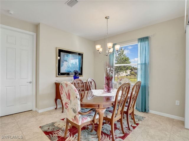 dining area featuring a notable chandelier and light tile patterned flooring