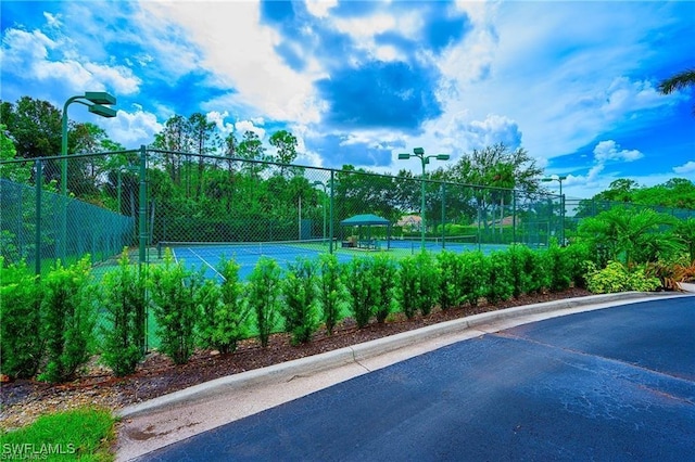 view of pool with tennis court