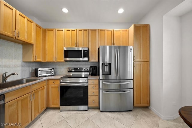 kitchen with sink, decorative backsplash, light tile patterned floors, light brown cabinetry, and stainless steel appliances