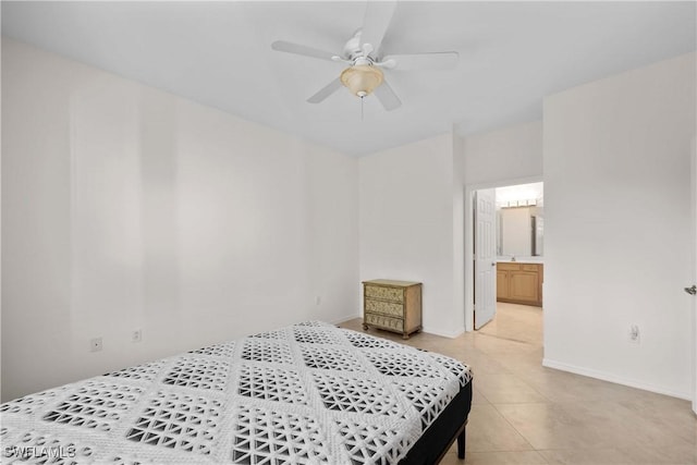 bedroom featuring ceiling fan, light tile patterned floors, and ensuite bath