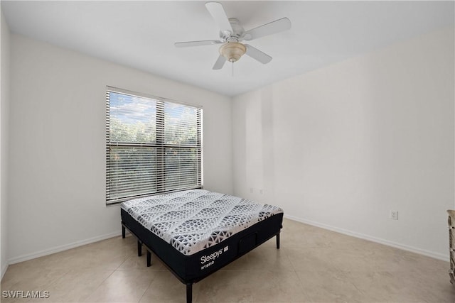 tiled bedroom with ceiling fan