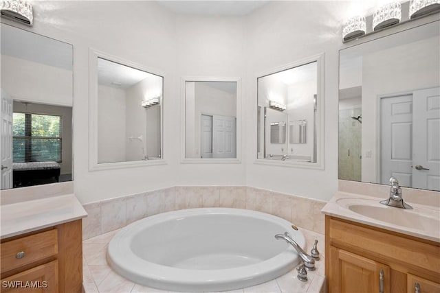 bathroom with vanity and separate shower and tub