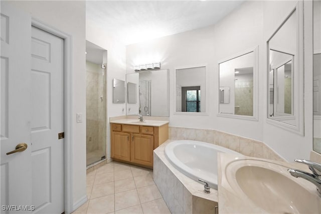 bathroom featuring tile patterned flooring, vanity, and separate shower and tub