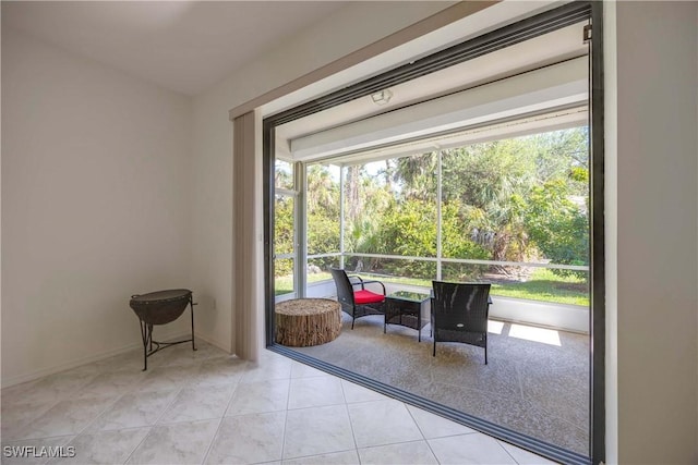 entryway featuring light tile patterned floors and plenty of natural light