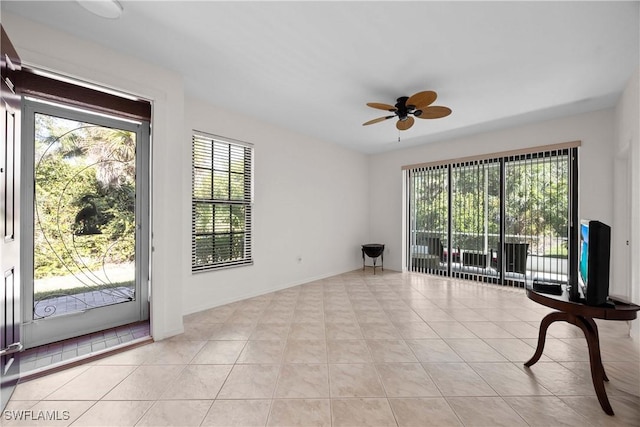 interior space with ceiling fan and light tile patterned flooring