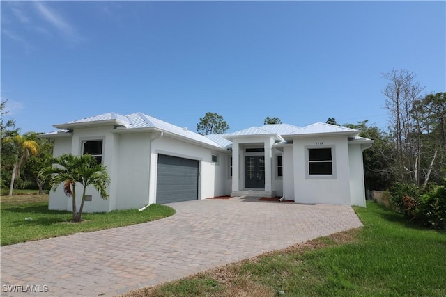 view of front facade with a garage and a front lawn