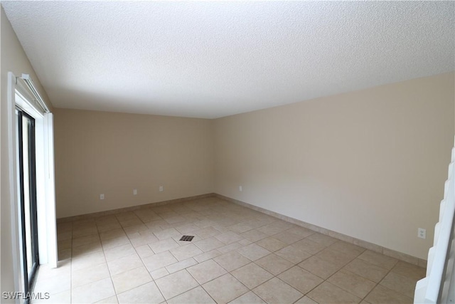 unfurnished room featuring a textured ceiling