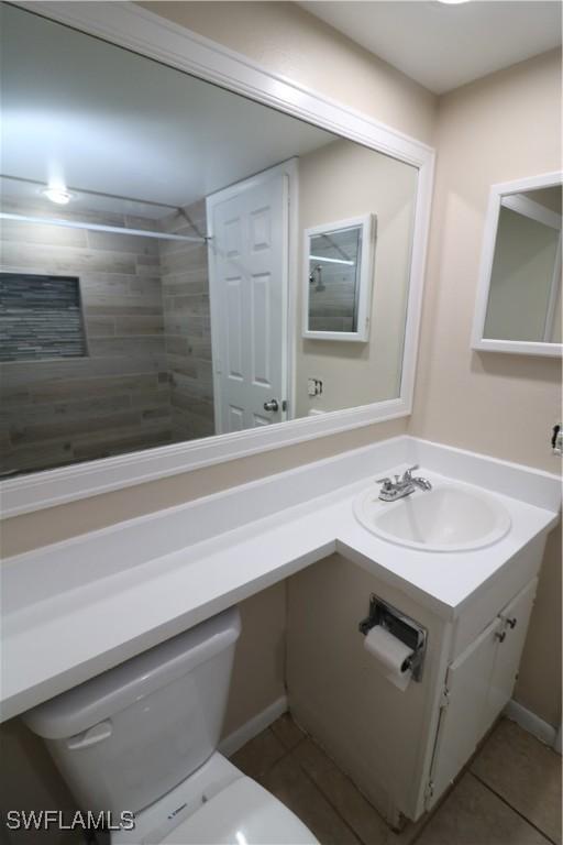 bathroom with tile patterned floors, vanity, and toilet