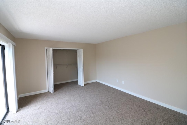 unfurnished bedroom with light carpet, a closet, and a textured ceiling