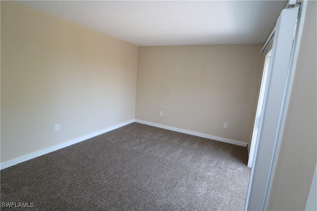 unfurnished bedroom featuring carpet flooring and a textured ceiling