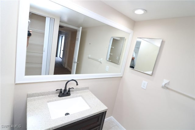 bathroom with tile patterned flooring and vanity