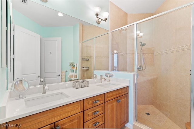 bathroom with vanity and a shower with shower door