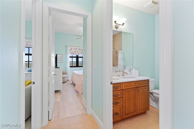 bathroom featuring hardwood / wood-style floors, vanity, toilet, and ceiling fan