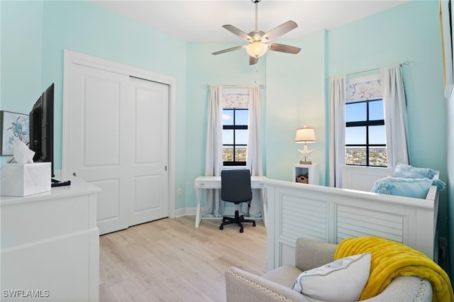 office space with light wood-type flooring and ceiling fan