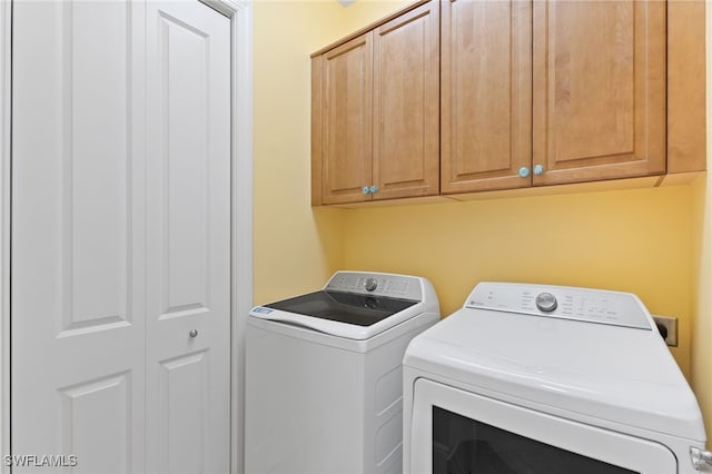 laundry area featuring cabinets and separate washer and dryer