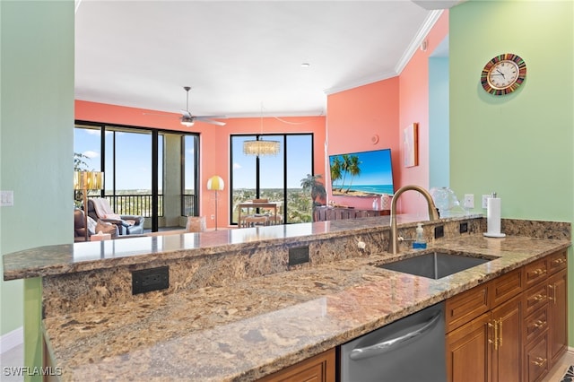 kitchen featuring light stone countertops, sink, stainless steel dishwasher, ceiling fan with notable chandelier, and ornamental molding