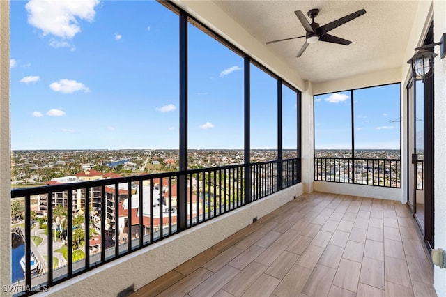 unfurnished sunroom featuring ceiling fan