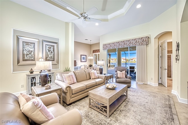 living room featuring ceiling fan and ornamental molding