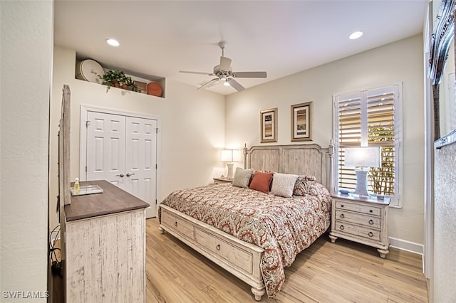 bedroom with ceiling fan, light wood-type flooring, and a closet