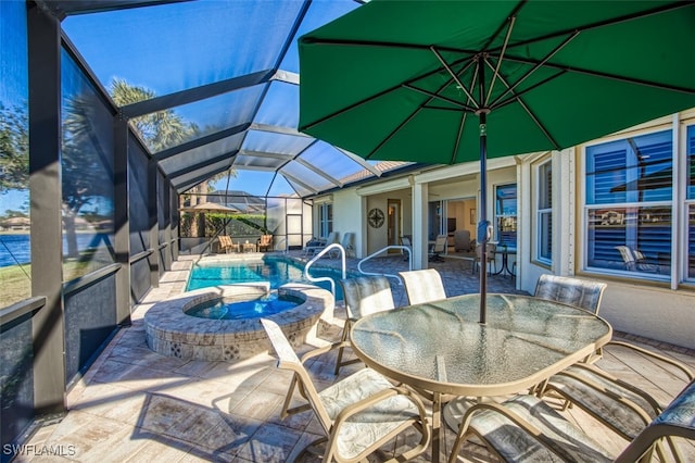 view of patio / terrace featuring glass enclosure and a pool with hot tub