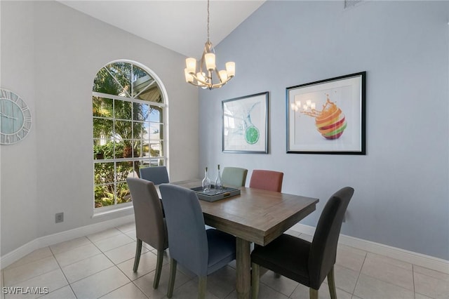 tiled dining space featuring an inviting chandelier and high vaulted ceiling