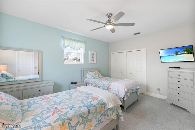 bedroom featuring a closet, light colored carpet, and ceiling fan