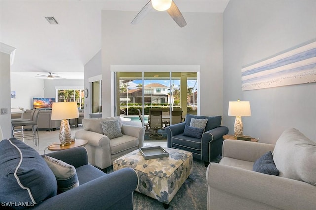 living room featuring ceiling fan, plenty of natural light, and high vaulted ceiling