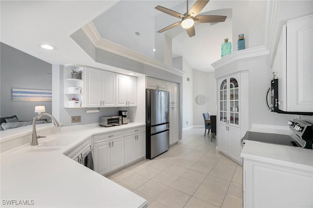 kitchen with white cabinets, sink, ceiling fan, light tile patterned floors, and appliances with stainless steel finishes