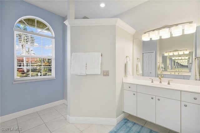 bathroom with tile patterned floors, vanity, and vaulted ceiling