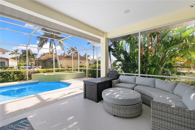 view of pool featuring outdoor lounge area, a patio, and glass enclosure