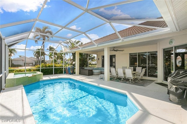 view of pool with ceiling fan, a patio, and glass enclosure