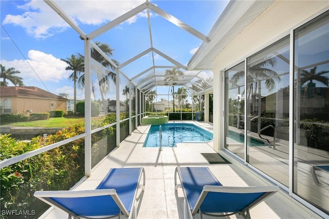 view of pool with a patio and a lanai