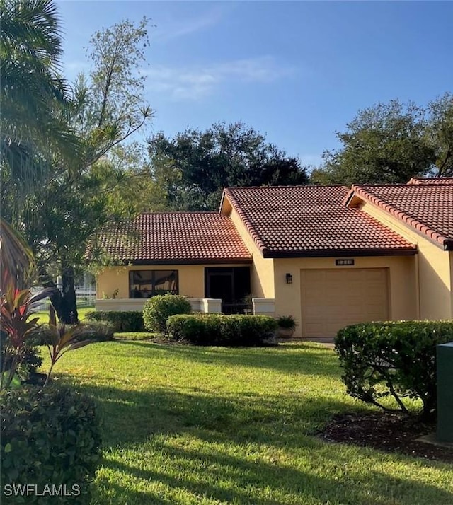 mediterranean / spanish-style house with a front lawn and a garage