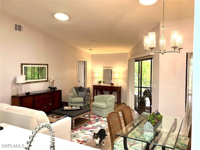 living room featuring vaulted ceiling and an inviting chandelier