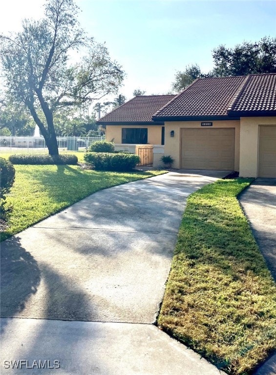 view of front facade featuring a front lawn and a garage