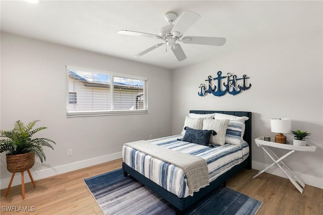 bedroom featuring hardwood / wood-style floors and ceiling fan