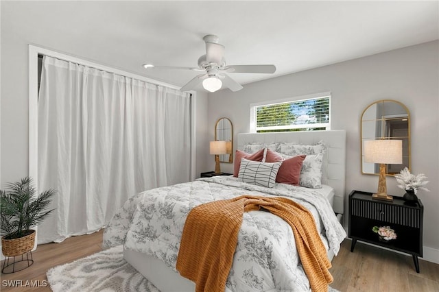 bedroom with light hardwood / wood-style flooring and ceiling fan