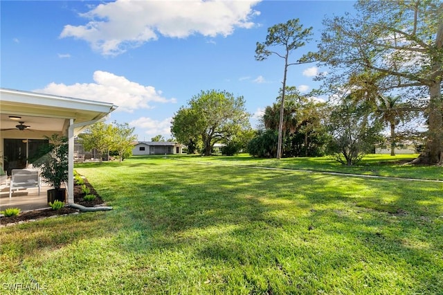 view of yard with ceiling fan