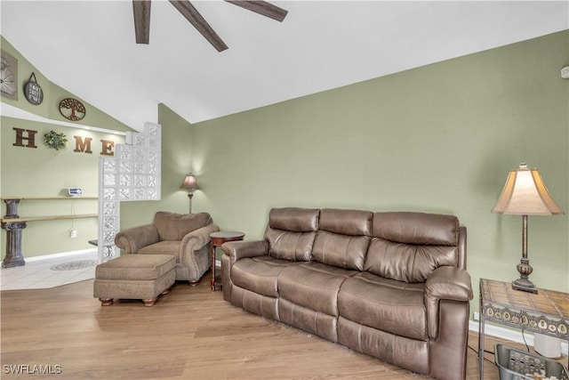 living room with ceiling fan, lofted ceiling, and light hardwood / wood-style flooring