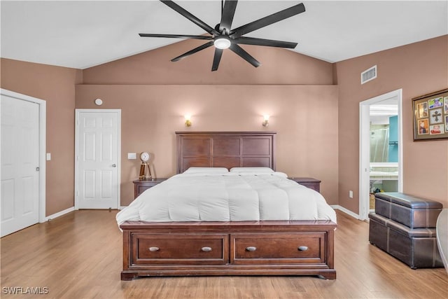 bedroom with ensuite bathroom, vaulted ceiling, ceiling fan, and light hardwood / wood-style floors