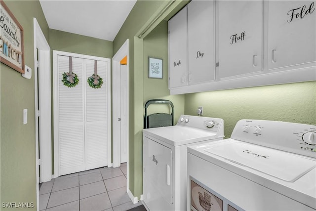 laundry area with separate washer and dryer, light tile patterned flooring, and cabinets