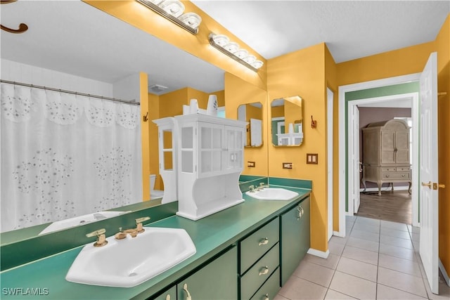 bathroom featuring walk in shower, tile patterned flooring, vanity, and toilet