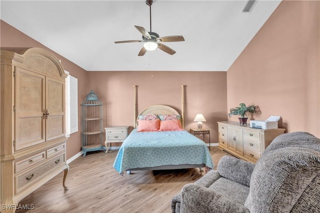 bedroom with ceiling fan, light wood-type flooring, and vaulted ceiling