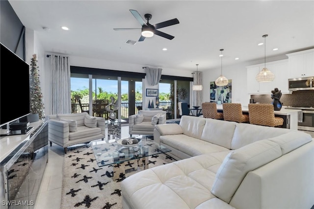 tiled living room with ceiling fan