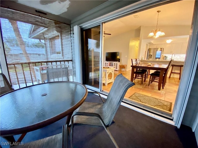 dining area with lofted ceiling and a notable chandelier