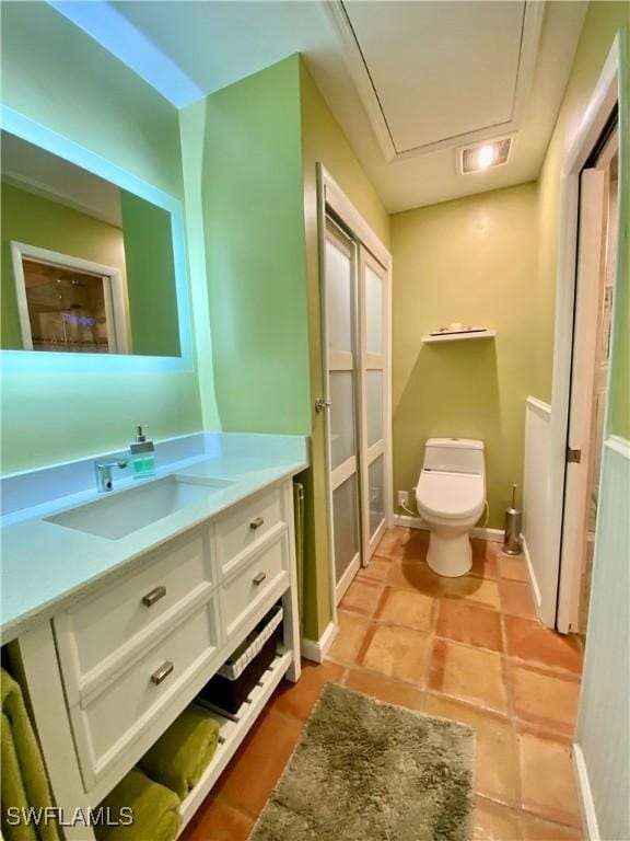 bathroom featuring vanity and toilet